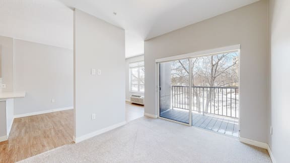 a bedroom with a sliding glass door leading to a balcony