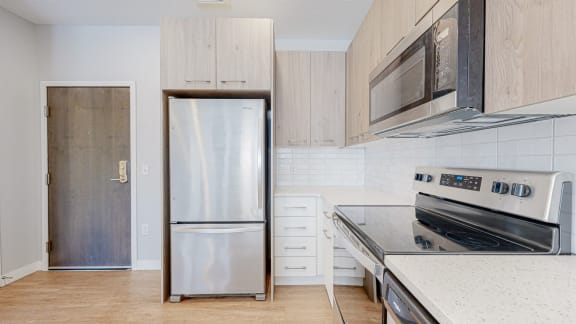 a kitchen with white cabinets and stainless steel appliances