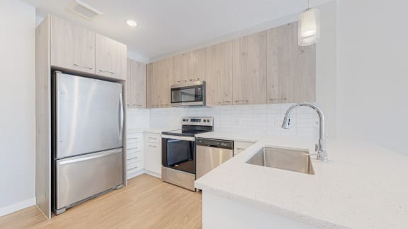 a kitchen with white cabinets and a white counter top