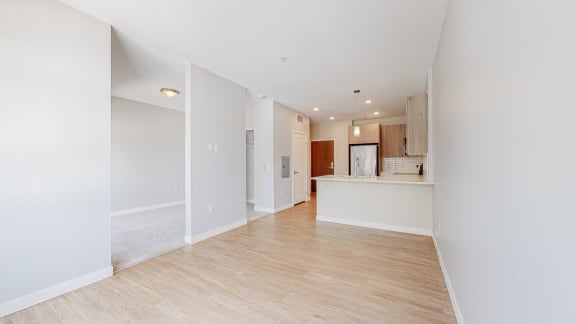 a bedroom with a medium sized bed and a kitchen with a breakfast bar