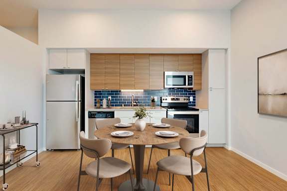 A modern kitchen with a dining table set for four.