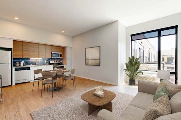 A modern living room with a grey sofa and a wooden coffee table.
