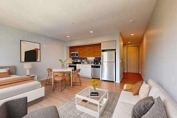 A modern living room with a grey couch and a coffee table.