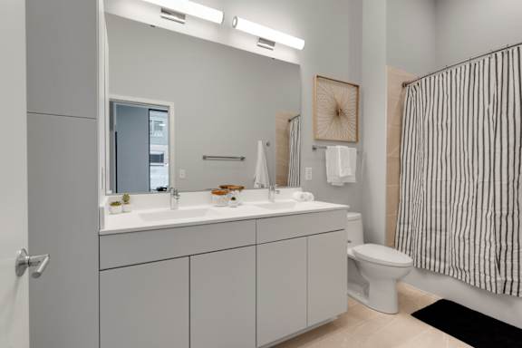 A bathroom with a white sink and toilet.