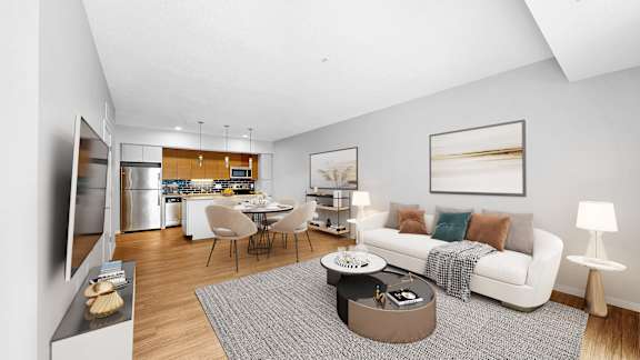 A modern living room with a kitchen in the background.