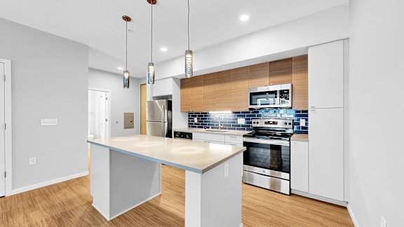 A modern kitchen with a large island in the middle.