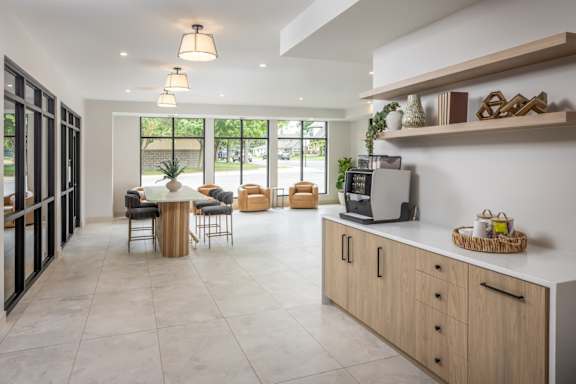 A kitchen with a table and chairs in the middle of the room.