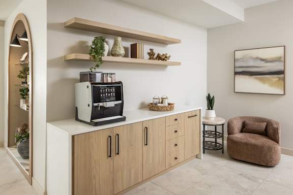 A modern kitchen with a coffee machine on the counter.