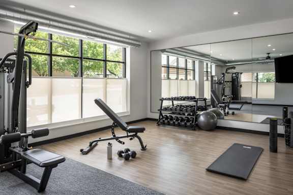 A well-equipped home gym with a variety of exercise equipment.