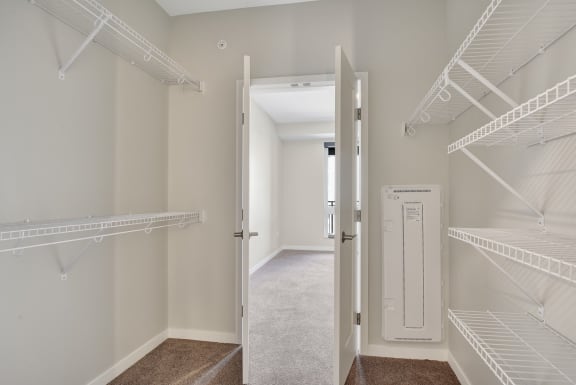 a walk in closet at the enclave at woodbridge apartments in sugar land, tx