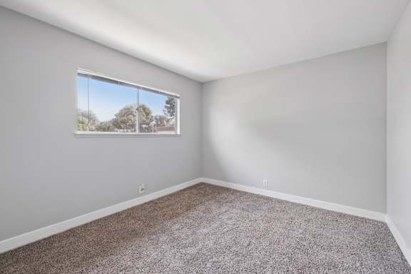 Spacious empty room with natural light at Ocean Villas Apartments, California