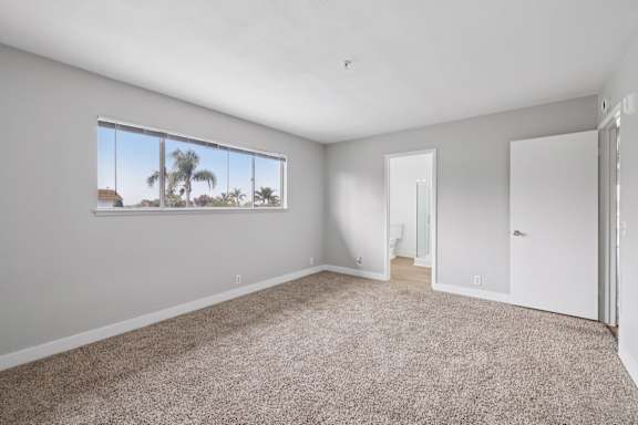Bedroom with attached bath at Ocean Villas Apartments, California