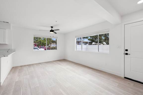 Room with ceiling fan and natural light at Ocean Villas Apartments, Oxnard