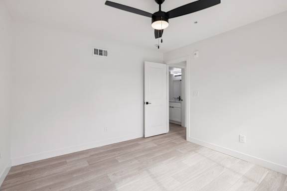 Bedroom with ceiling fan and light at Ocean Villas Apartments, Oxnard, CA, 93033