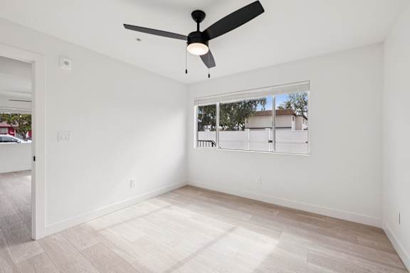 Bedroom with ceiling fan at Ocean Villas Apartments, Oxnard, California