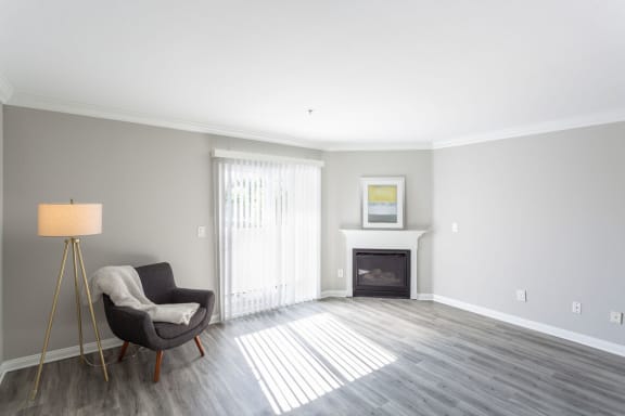 a living room with a chair and a fireplace at Warner Center Townhomes, Canoga Park California