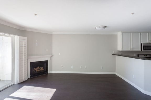 a living room with a fireplace and a kitchen at Warner Center Townhomes, Canoga Park