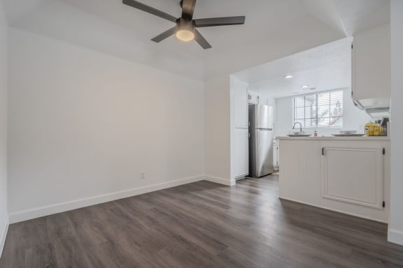a kitchen and living room with a ceiling fan  at The Resort at Encinitas Luxury Apartment Homes, Encinitas, CA