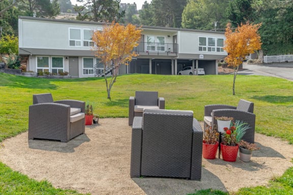 a patio with chairs and a table in front of a building at Trailhead Apartments at Tam Junction, Mill Valley, CA 94941