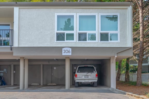 a car is parked in the parking lot of a building at Trailhead Apartments at Tam Junction, California