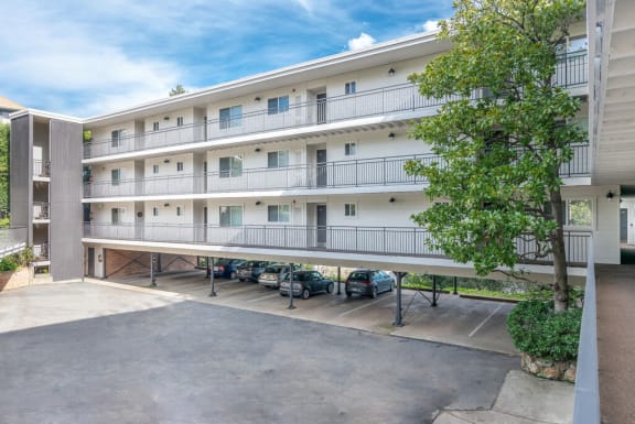 a large white apartment building with cars parked in front of it at The Pier at Sausalito, Sausalito, CA