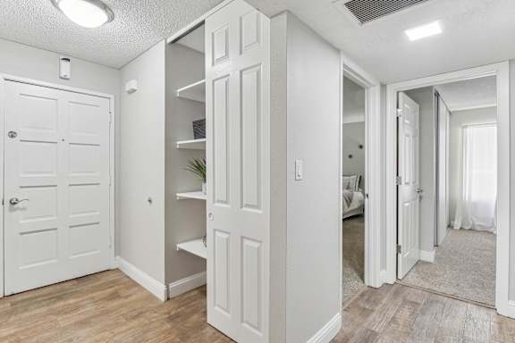 a walk in closet with white closets and mirrored doors at Summerwood Apartments, Santa Clara, 95050