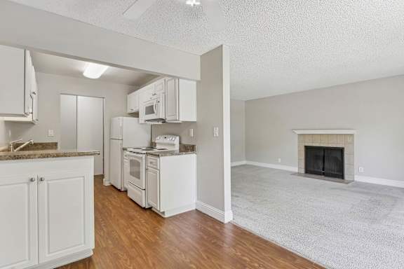 a view of a kitchen and a living room with a fireplace at Summerwood Apartments, California, 95050
