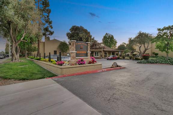 a street in front of a house with a driveway and a sign at Summerwood Apartments, Santa Clara, CA 95050