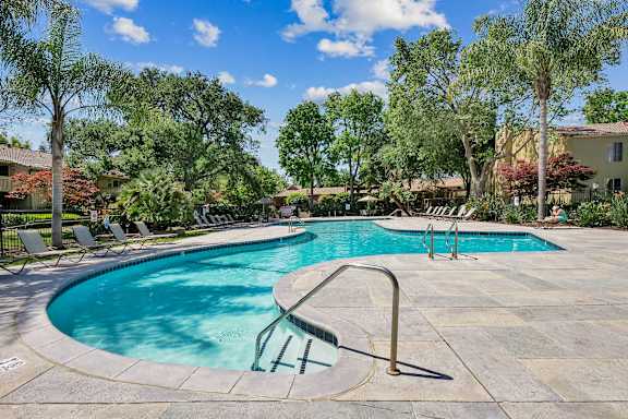 a swimming pool with trees at Summerwood Apartments, Santa Clara, CA