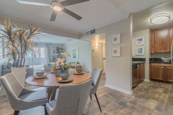 a dining room and kitchen with a table and chairs at City View Apartments at Warner Center, Woodland Hills, CA 91367