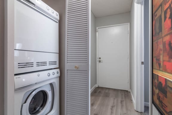 a washer and dryer in a laundry room with a doorat Sunnyvale Crossings Apartments, LLC, California, 94087