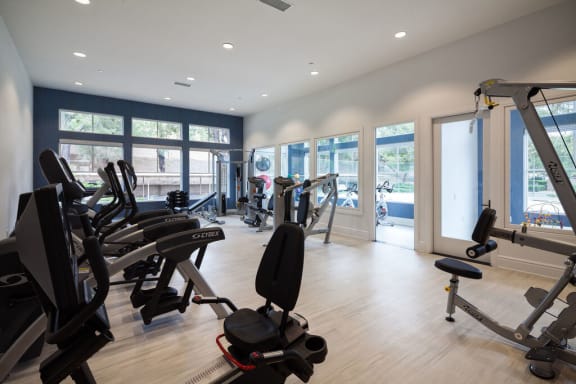 a gym with cardio equipment and windows in a building at The Bryant, Yorba Linda, CA
