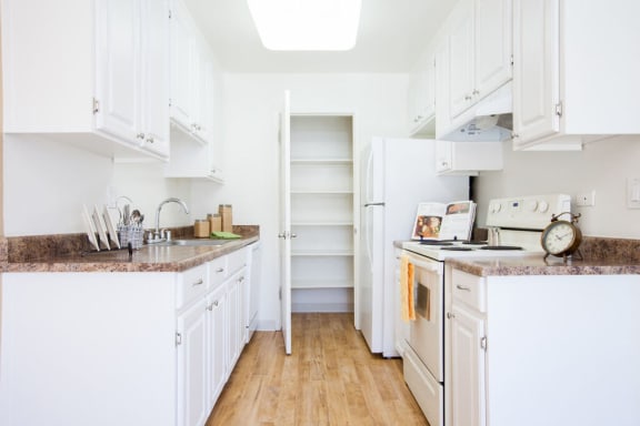 a kitchen with white cabinets and a white refrigerator at Campbell West Apartments, Campbell, CA 95008