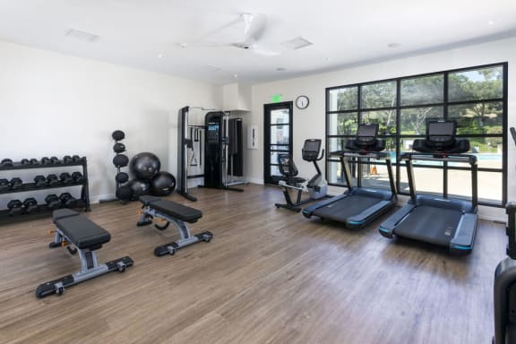 the gym is equipped with weights and cardio equipment at La Jolla Blue, San Diego, CA