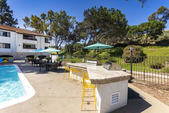 a patio with a bar and a swimming pool at La Jolla Blue, San Diego California
