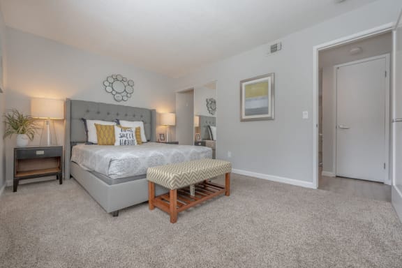 a bedroom with a king sized bed and a door to a bathroom at Napa Green Apartments LLC, Napa, CA