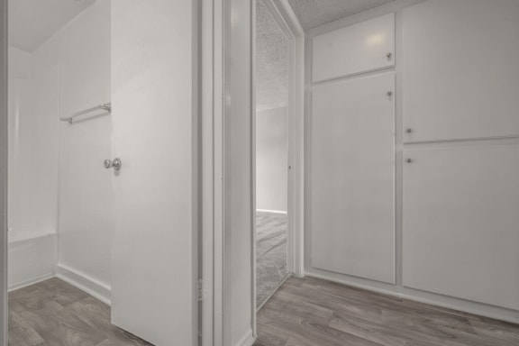 a white bedroom with a door to a closet at Ocean Villas, Oxnard, 93033
