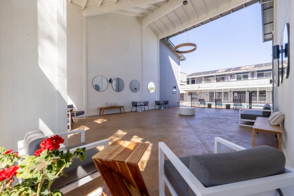 a living area with a couch and a table and a large window at Campbell West Apartments, Campbell, 95008