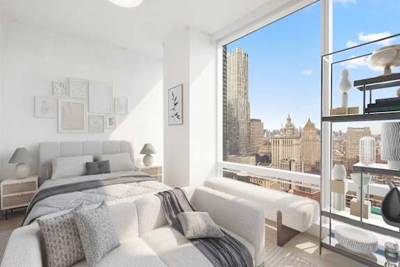 A bedroom with a large bed and a view of the city.