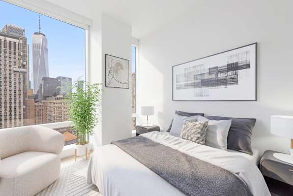 A bedroom with a large bed and a view of the city.