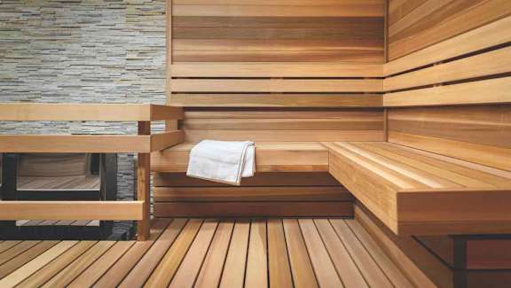 a sauna with wooden steps and a white towel at SKY Apartments, New York