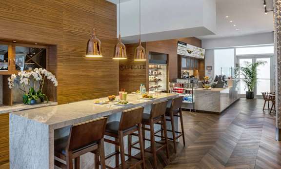 a kitchen with a marble counter top at SKY Apartments, New York, NY