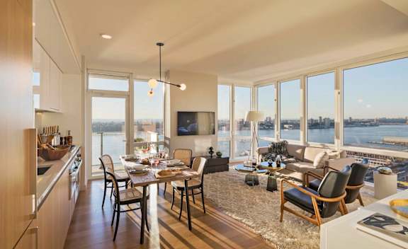 a rendering of a living room and dining room with a view of the water at SKY Apartments, New York, NY, 10036