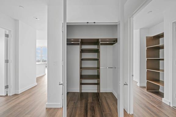 a small loft with a ladder in a white room at SKY Apartments, New York 10036