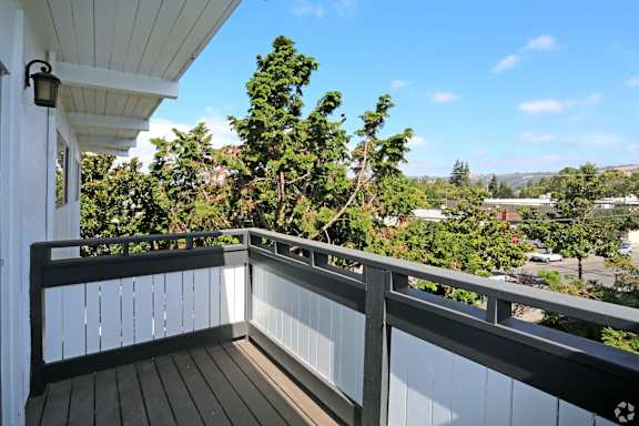 A balcony with a railing and a view of a town.