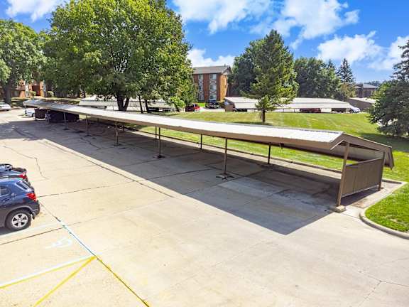 Covered car park with multiple parking spaces, providing shade and protection.
