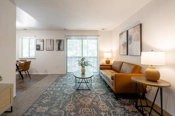 a living room with a rug and a couch and a table
