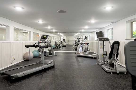 A gym with treadmills and exercise equipment.