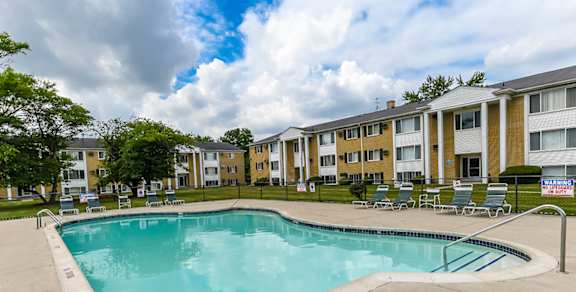 A swimming pool in front of apartment buildings.