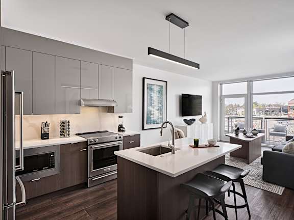 A modern kitchen with a large island and stainless steel appliances.